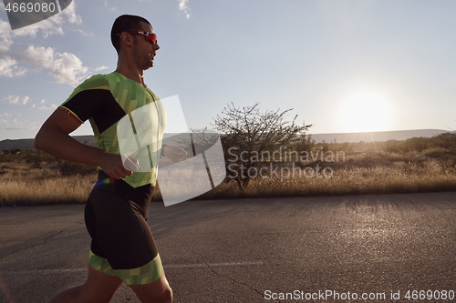 Image of triathlon athlete running on morning trainig