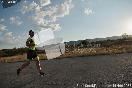 Image of triathlon athlete running on morning trainig