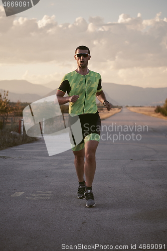 Image of triathlon athlete running on morning trainig