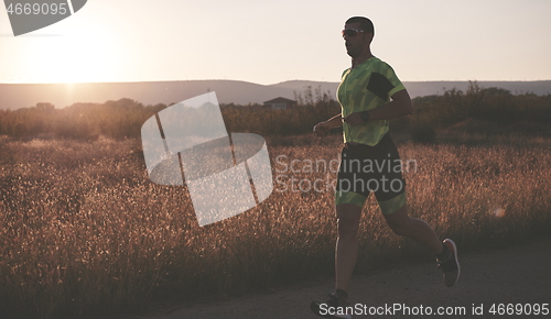 Image of triathlon athlete running on morning trainig