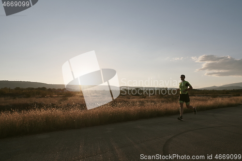 Image of triathlon athlete running on morning trainig