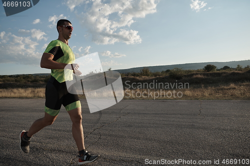 Image of triathlon athlete running on morning trainig