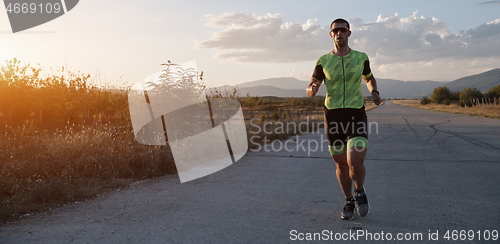 Image of triathlon athlete running on morning trainig