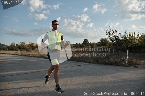 Image of triathlon athlete running on morning trainig