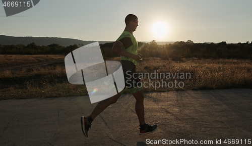 Image of triathlon athlete running on morning trainig