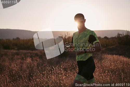 Image of triathlon athlete running on morning trainig