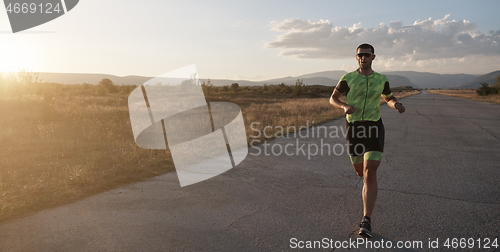 Image of triathlon athlete running on morning trainig