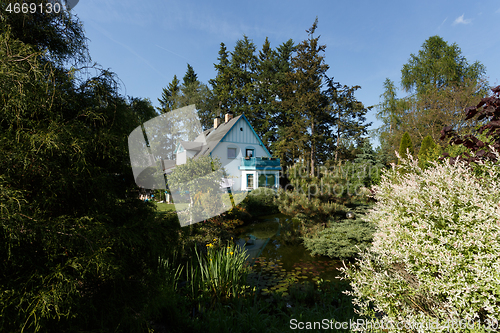 Image of Beautiful rural house in spring garden