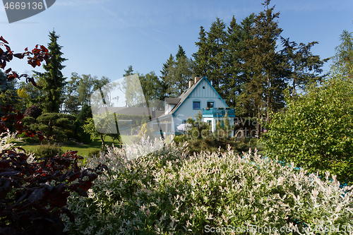 Image of Beautiful rural house in spring garden