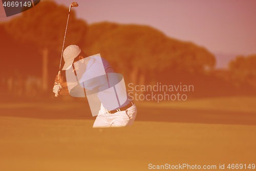 Image of pro golfer hitting a sand bunker shot