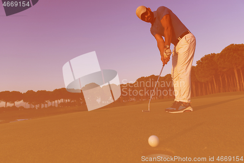 Image of golfer  hitting shot at golf course