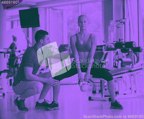 Image of young sporty woman with trainer exercise weights lifting