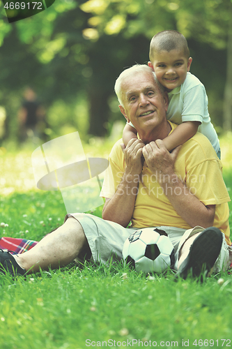 Image of happy grandfather and child in park