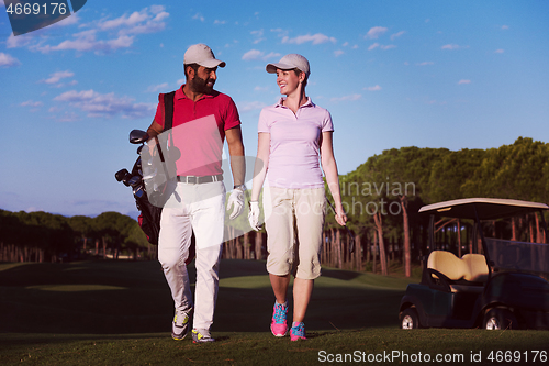 Image of couple walking on golf course