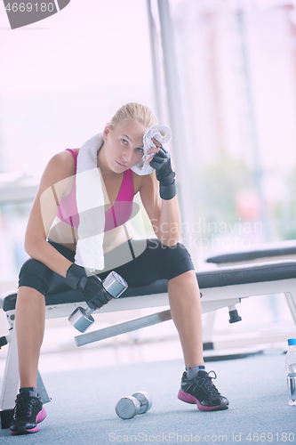 Image of young woman exercise with dumbells