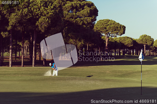 Image of pro golfer hitting a sand bunker shot