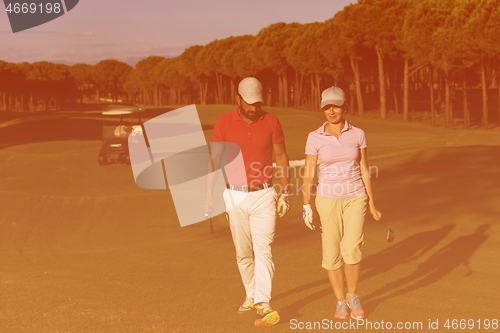 Image of couple walking on golf course