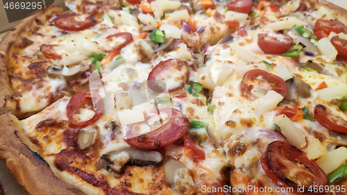 Image of Pizza with mushrooms, tomato and pineapple