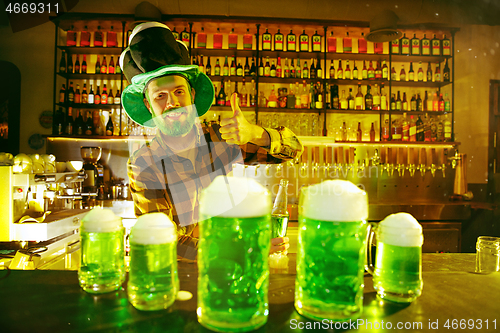 Image of Happy man with glass of beer looking aside in pub