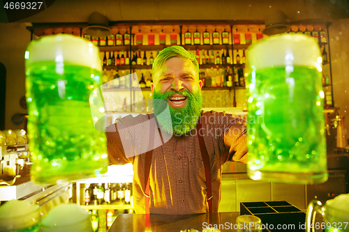 Image of Happy man with glass of beer looking aside in pub