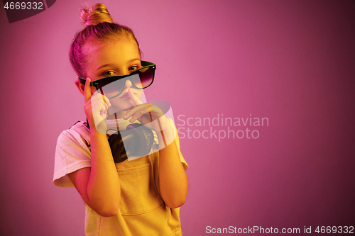 Image of Young girl with headphones enjoying music