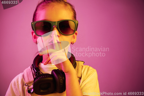 Image of Young girl with headphones enjoying music