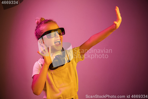 Image of Young girl with headphones enjoying music