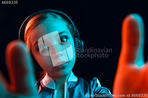 Image of Young girl with headphones enjoying music