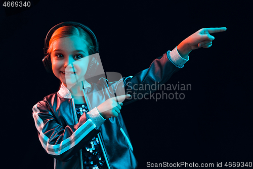 Image of Young girl with headphones enjoying music