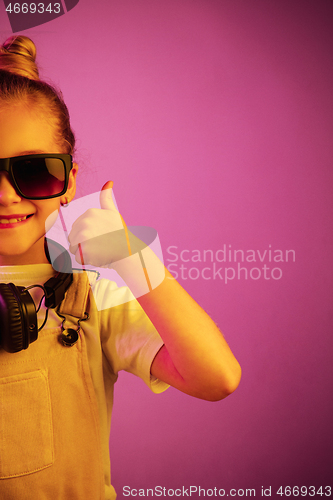 Image of Young girl with headphones enjoying music