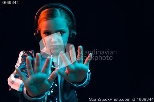 Image of Young girl with headphones enjoying music