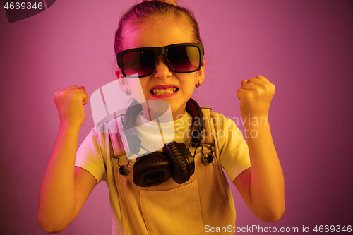 Image of Young girl with headphones enjoying music