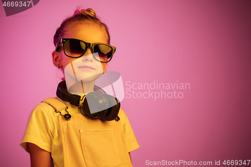 Image of Young girl with headphones enjoying music