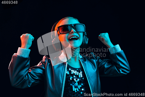 Image of Young girl with headphones enjoying music