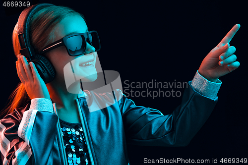 Image of Young girl with headphones enjoying music