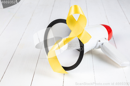 Image of Yellow ribbon symbolic color for Sarcoma Bone cancer awareness and suicide prevention