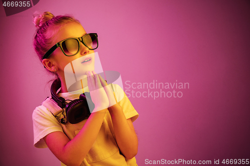 Image of Young girl with headphones enjoying music