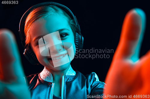 Image of Young girl with headphones enjoying music