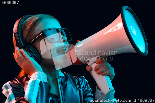 Image of Young girl with headphones enjoying music