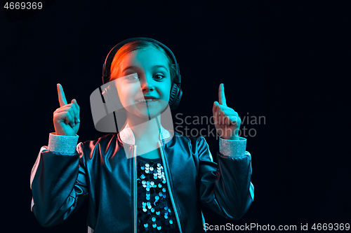 Image of Young girl with headphones enjoying music