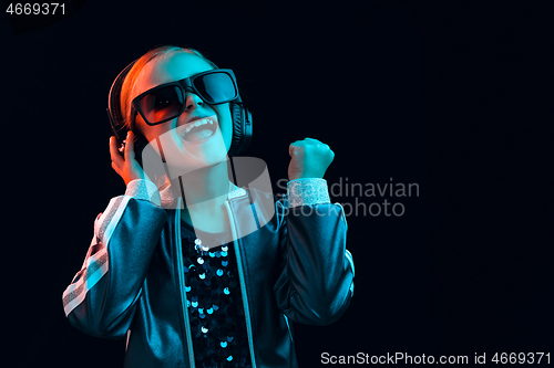 Image of Young girl with headphones enjoying music