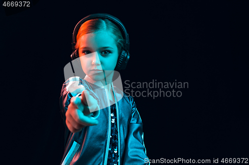 Image of Young girl with headphones enjoying music