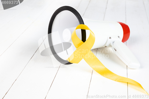 Image of Yellow ribbon symbolic color for Sarcoma Bone cancer awareness and suicide prevention