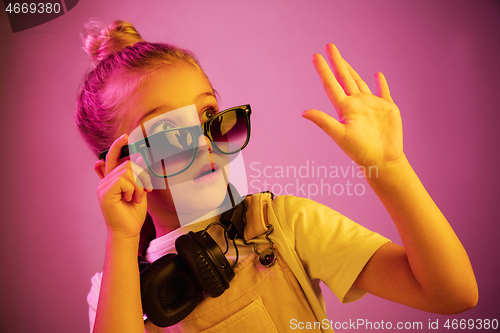 Image of Young girl with headphones enjoying music