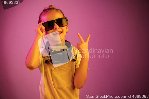 Image of Young girl with headphones enjoying music