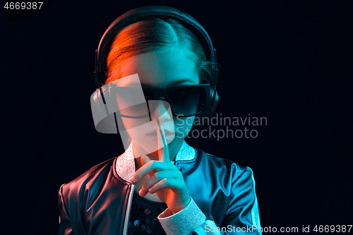 Image of Young girl with headphones enjoying music