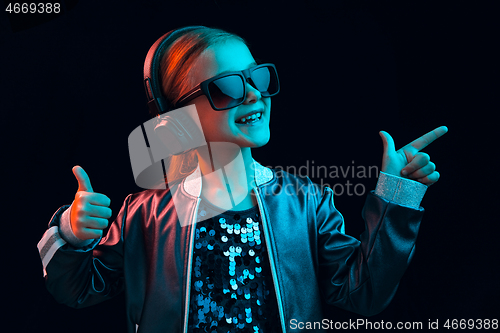 Image of Young girl with headphones enjoying music