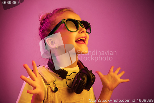 Image of Young girl with headphones enjoying music