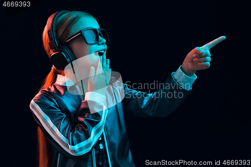 Image of Young girl with headphones enjoying music