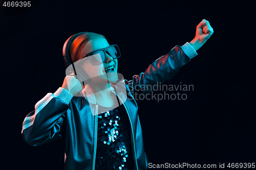 Image of Young girl with headphones enjoying music